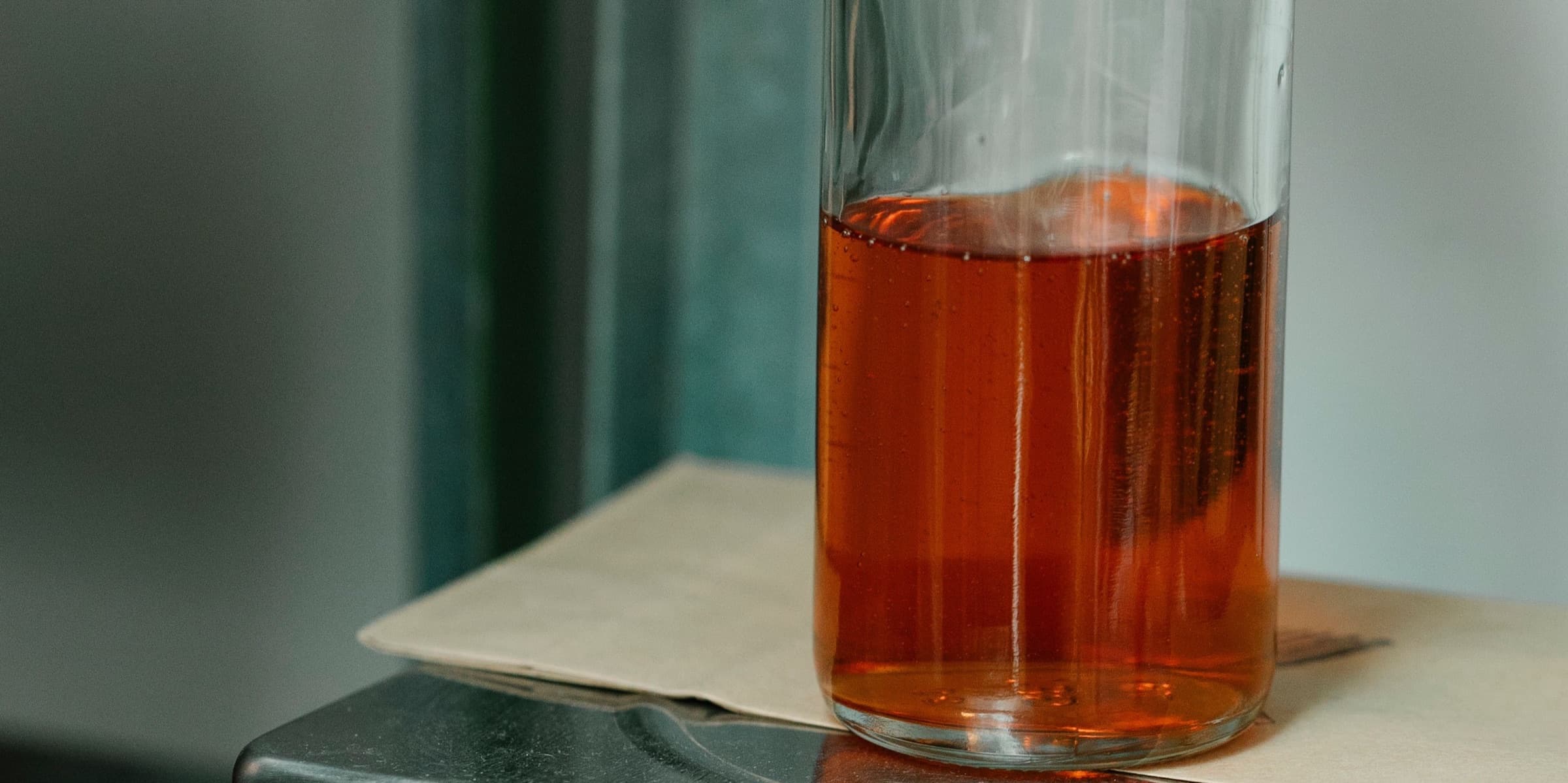 Bottle of liquid weighed on a digital laboratory scale