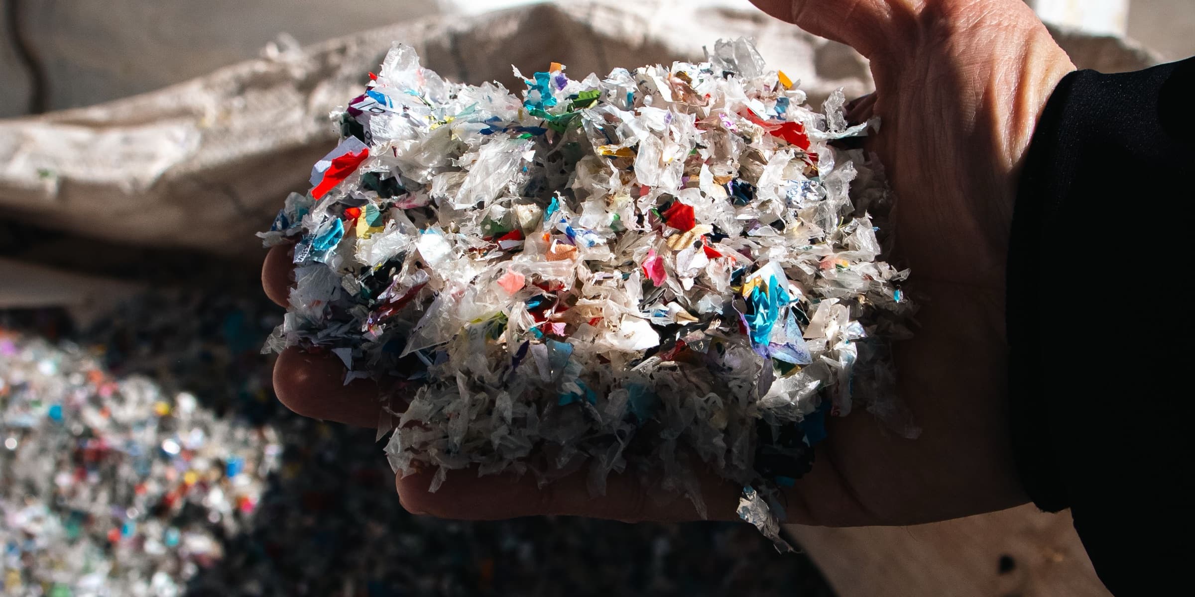 Recycled plastic granules held in a hand