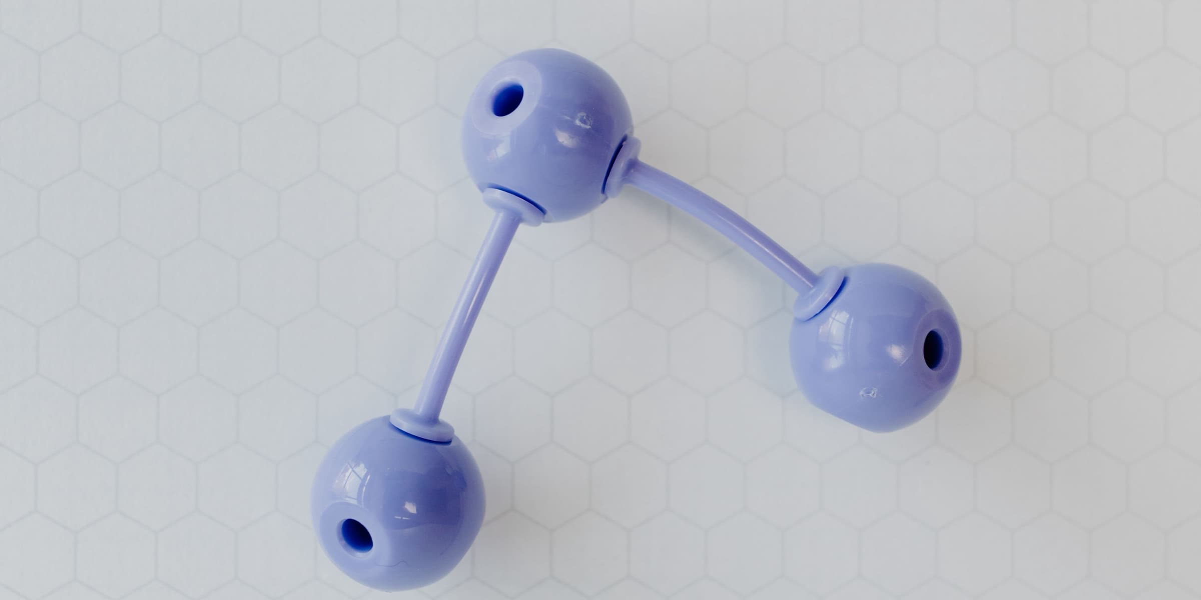 Purple molecular model on a hexagonal grid